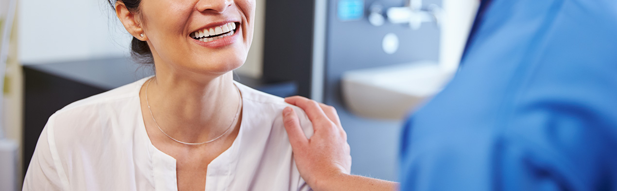 Nurse with hand on patients shoulder 