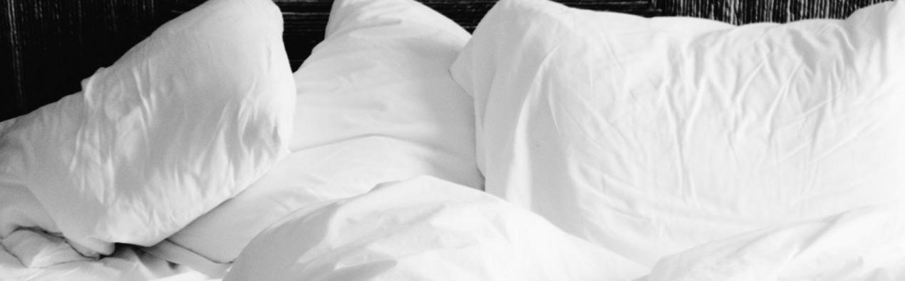 sleep bed with white duvet and pillows