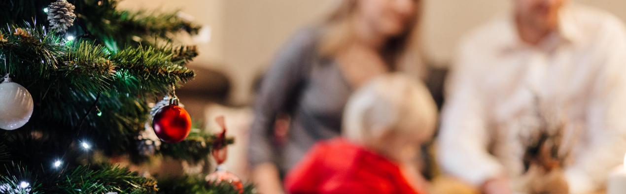 Family sitting around christmas tree